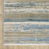 10' X 13' Ivory Beige Grey Blue And Tan Abstract Power Loom Stain Resistant Area Rug With Fringe