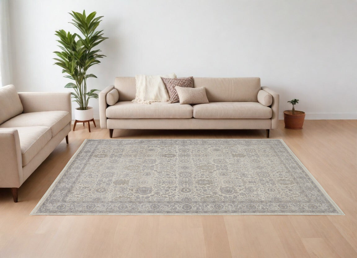 7' X 10' Gray and Ivory Oriental Power Loom Worn Faded Area Rug With Fringe